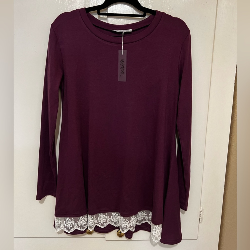 Flows long sleeve with lace hem.